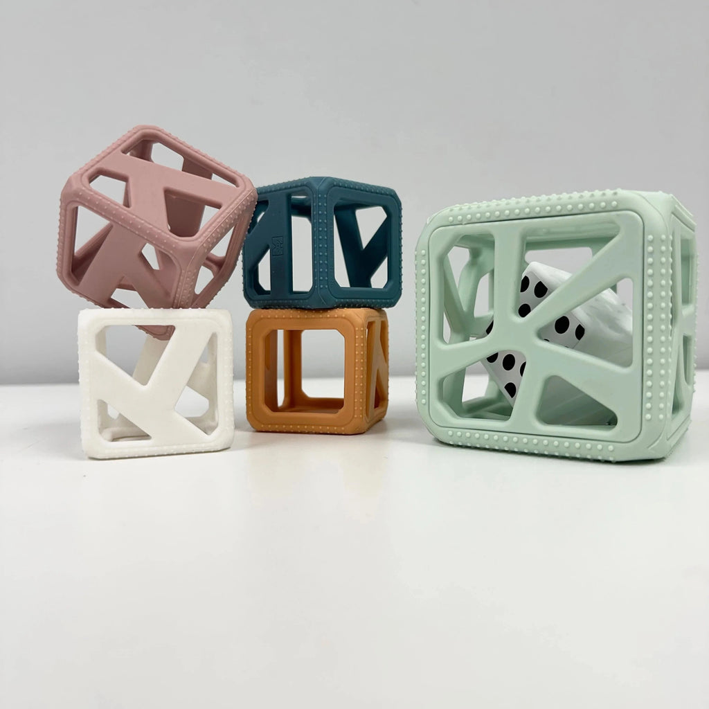 Set of colorful geometric baby blocks on a light gray background