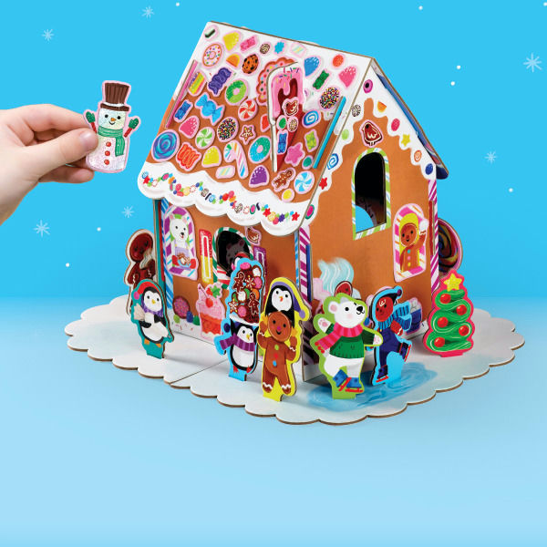 Colorful gingerbread house model with decorative figures on a blue background