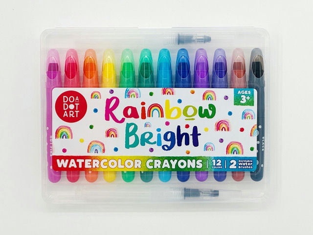 Set of rainbow bright watercolor crayons in a clear case on a white background