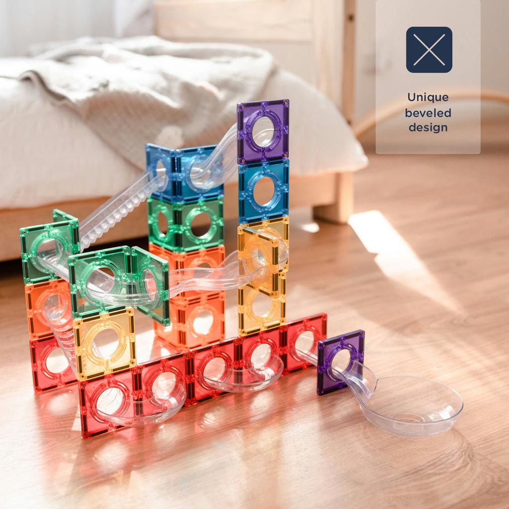 Colorful magnetic building blocks on a wooden surface with a couch in the background