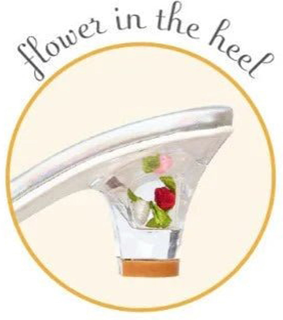Shoe with a flower in the heel on a beige background