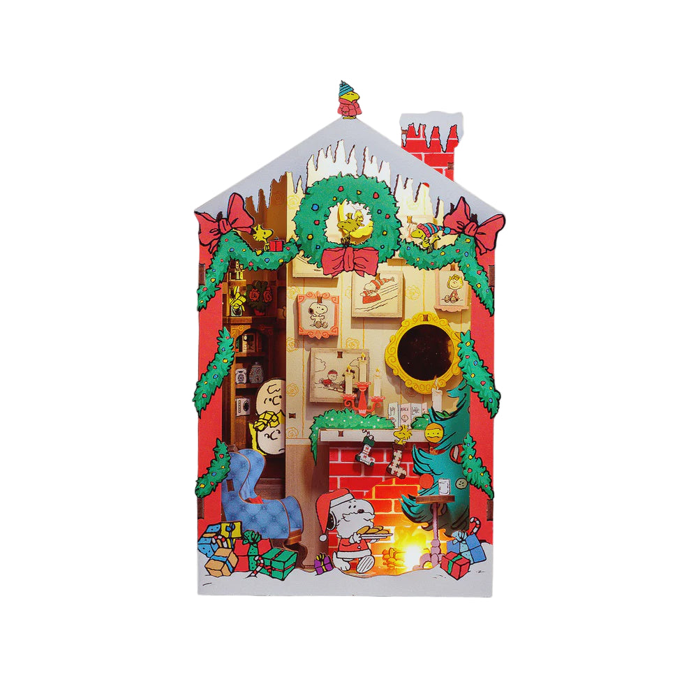 Decorative Christmas book nook with a house design featuring peanuts characters and festive elements.