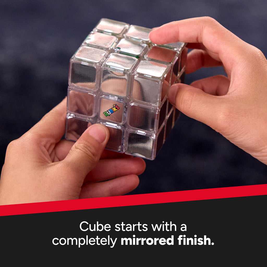 Person holding a mirrored Rubik's Cube with a dark background