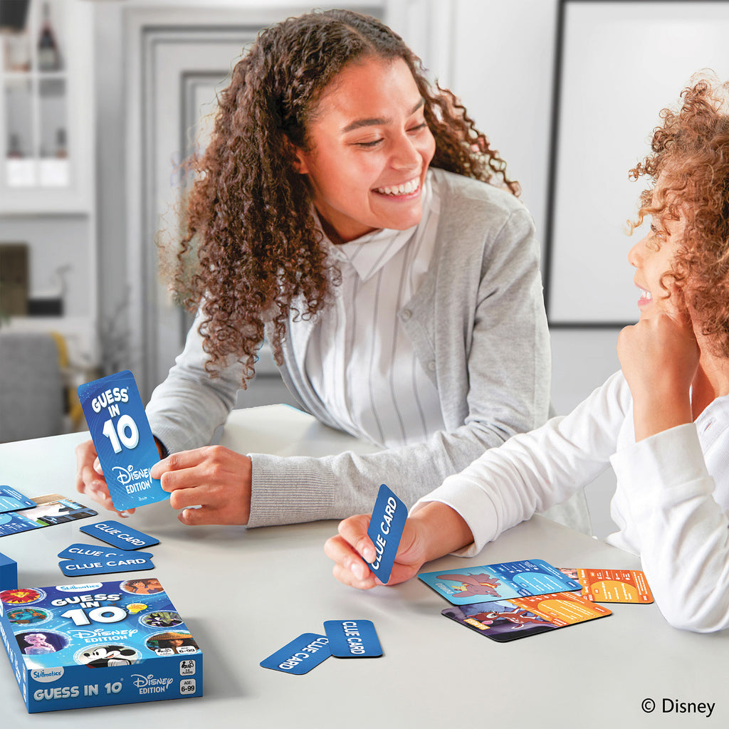 Two people playing a card game with Disney cards in a home setting