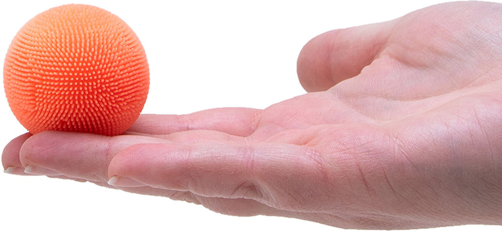 Orange ball on a person's palm against a white background