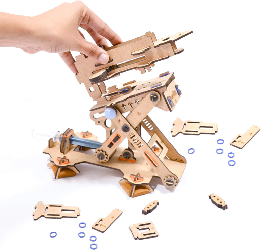 Wooden mechanical model kit with components on a white background