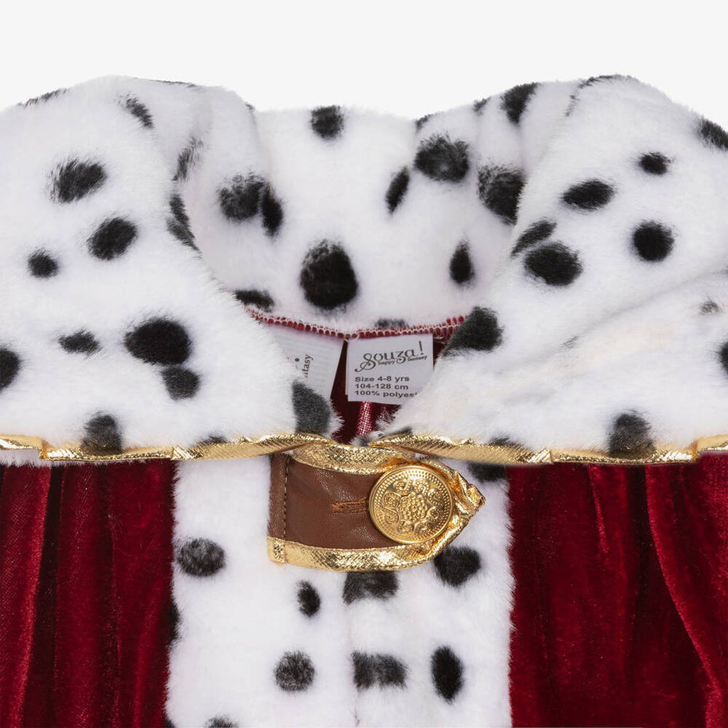 Close-up of a plush toy with white fur, black spots, red trim, and a gold tag on a white background.