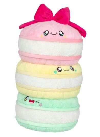 Stack of colorful plush toys with smiling faces on a white background