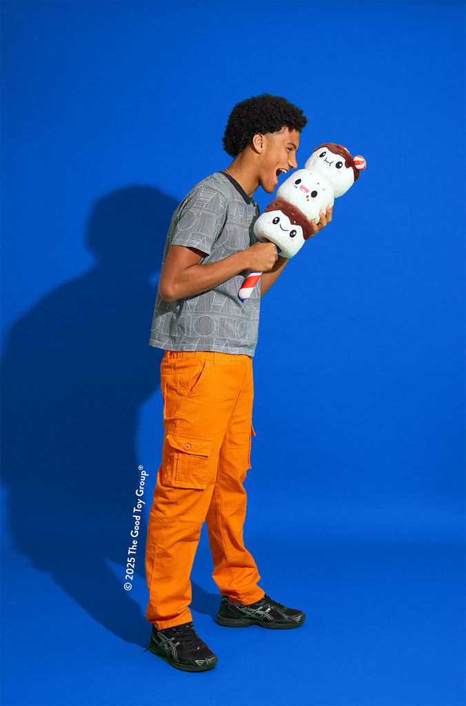 Person holding a plush toy against a blue background