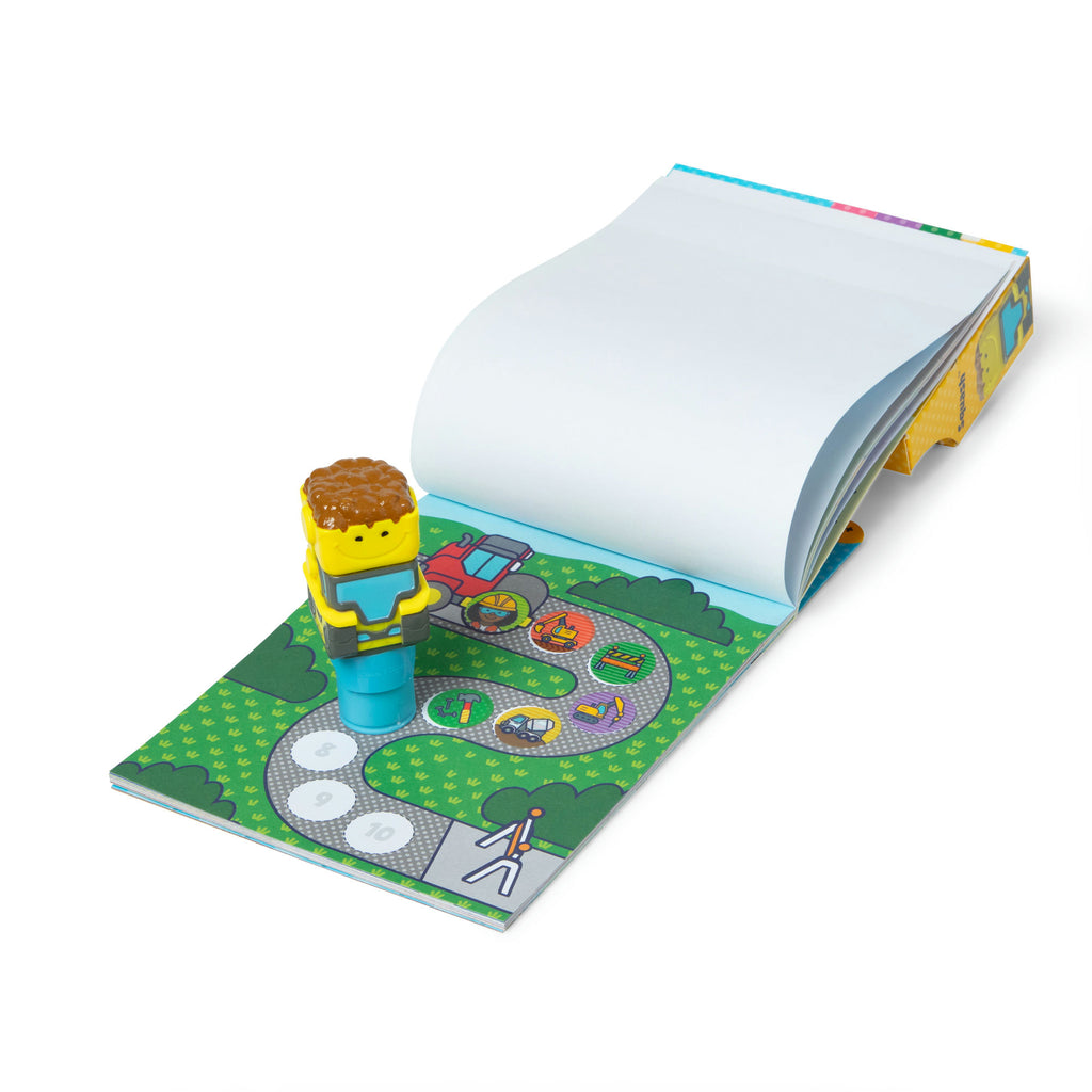 Sticker Wow! construction sticker stamper interacting with a small book with a road and vehicle illustration on a white background