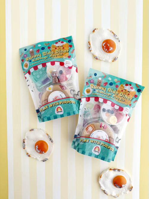Two packages of 'Sunny Side Diner' play set with toy eggs on a striped background
