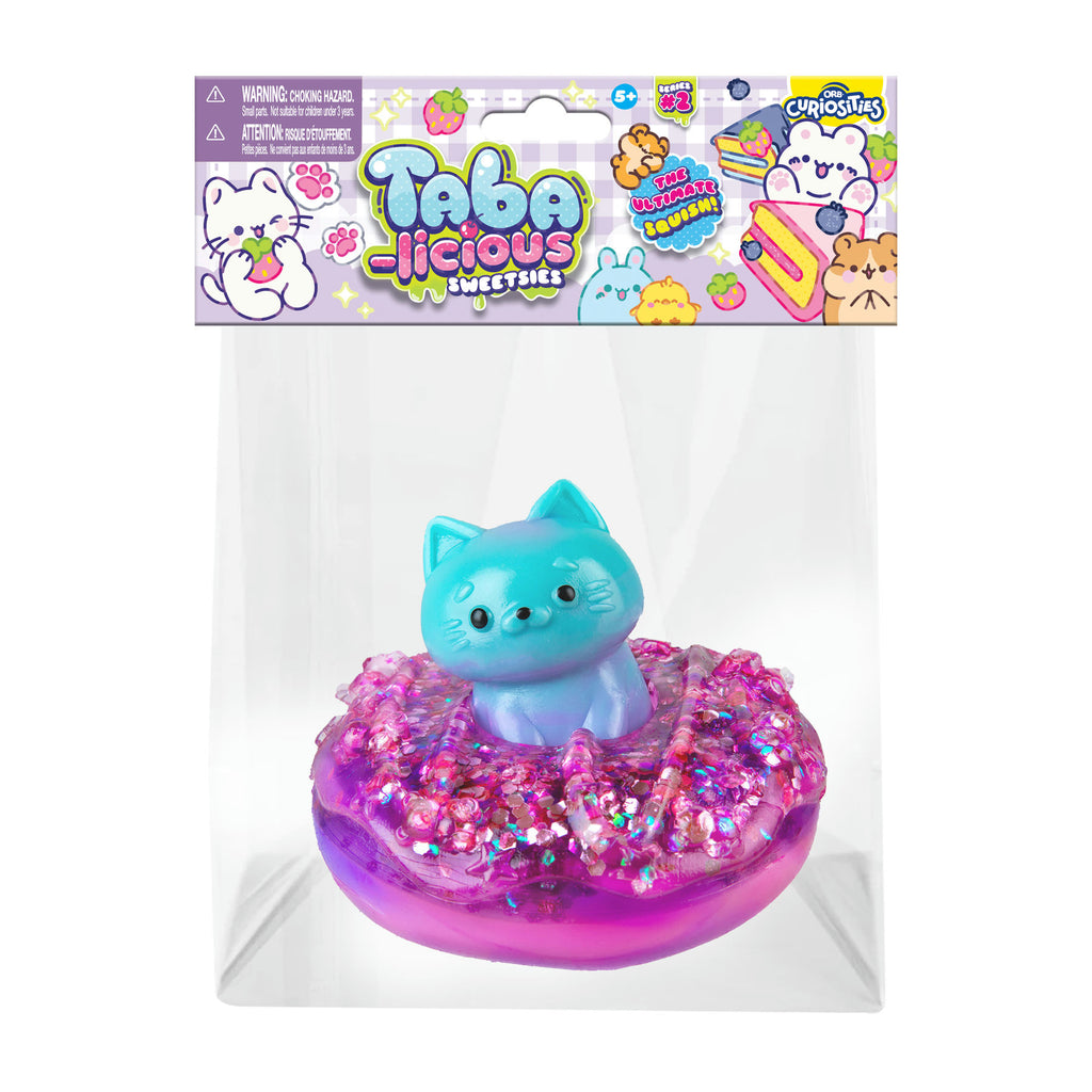 Toy figure of a cat on a pink donut with 'Tabacolicious' packaging.