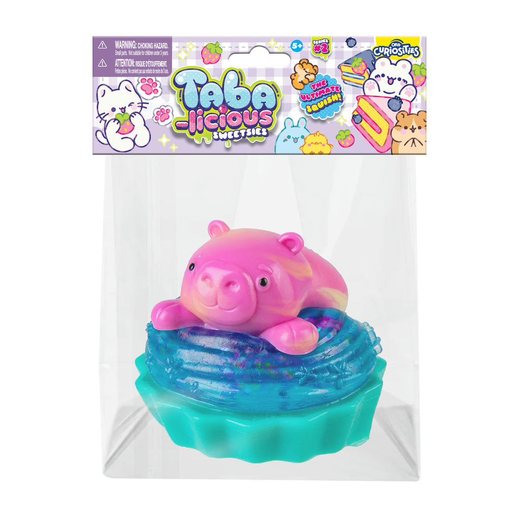 Pink and blue toy capybara in a clear package with Taba packaging above