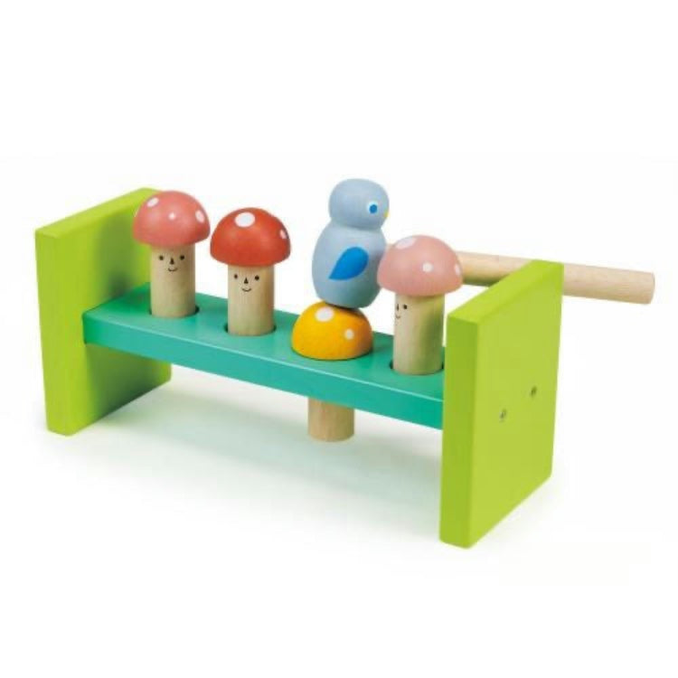 Colorful wooden toy set with mushrooms and a bird on a green base.