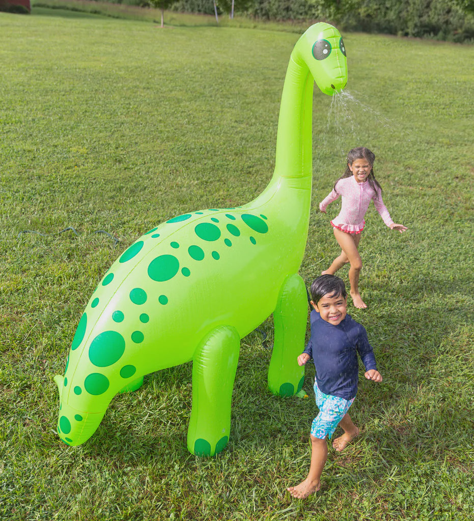 Image of Giant Dino Sprinkler on grass with 2 children.