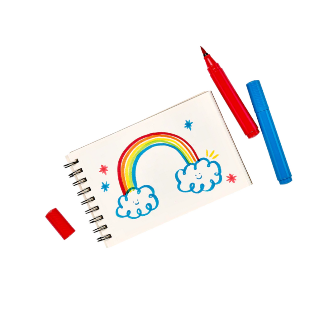 Image of drawing pad with rainbow design and 2 big bright brush markers next to it